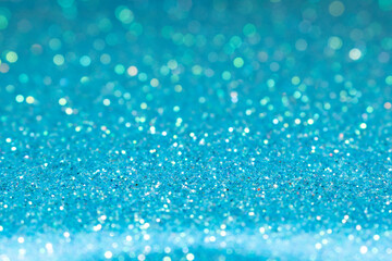 Blue festive glitter background. Shallow depth of field, blurred bokeh effect.