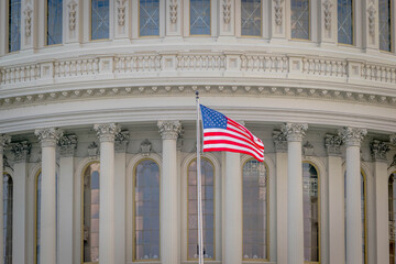 the american flag and dome of the capitol building in washington