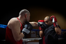Determined Male Boxers Training In Health Club In The Ring
