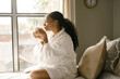 © Melissa Alexander/Creative Flame - Woman drinking coffee at home in bed