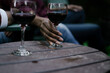 © Melissa Alexander/Creative Flame - Black woman reaches for glass of red wine at party