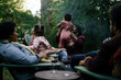 © Melissa Alexander/Creative Flame - Black friends safely gathered and enjoying a backyard kickback party with children