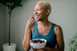 © Melissa Alexander/Creative Flame - Black woman eating healthy fruit and berries