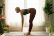 © Melissa Alexander/Creative Flame - Young woman practices yoga at home