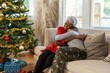 © Lynsey Weatherspoon/Creative Flame - Grandmother and grandson sharing special moment on Christmas