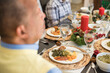 © Lynsey Weatherspoon/Creative Flame - Black family eating Christmas dinner together at dining room table