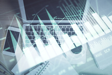 Stock market chart and top view computer on the table background. Double exposure. Concept of financial analysis.