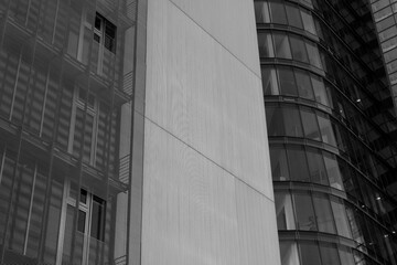 Wall Mural - Black and white tone, Exterior architectural detail of mixture facade elements and material of modern office buildings. Abstract Urban metropolis background.