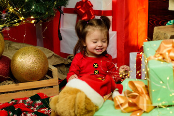 Wall Mural - Amazed attractive baby girl in Christmas costume.