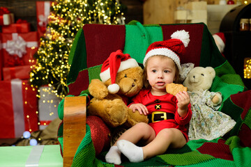 Wall Mural - Christmas portrait of cute little baby in santa hat. New Year kids holidays.