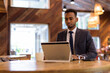 © Ranta Images - Young African businessman using laptop computer at coffee shop