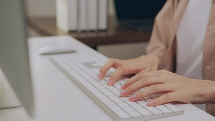 Wall Mural - Close up of hand typing on the computer keyboard, on wooden desk.