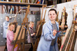 © JackF - Glad young female students practicing their skills during painting class at art studio