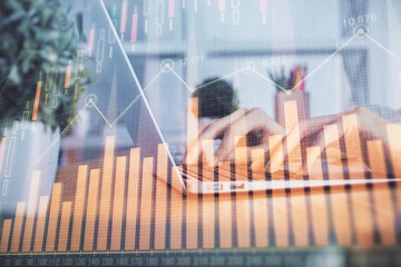 Double exposure of woman hands typing on computer and forex chart hologram drawing. Stock market invest concept.