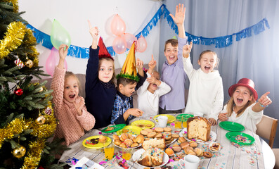 Wall Mural - Happy children having good time during Christmas dinner