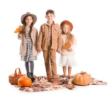 Cute Little Children In Autumn Clothes And With Pumpkins On White Background