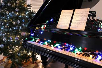 Grand piano decorated for Christmas in room