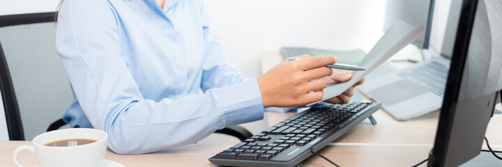 asian woman programming working with computer and typing data code to developing program at table in