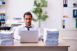 © Elnur - Young male employee unhappy with excessive work