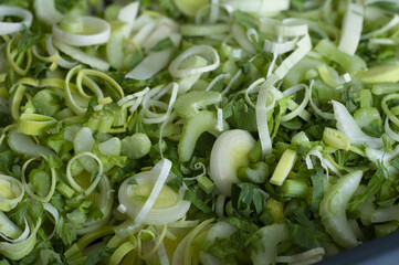 Canvas Print - Closeup of cut onions mixed with herbs