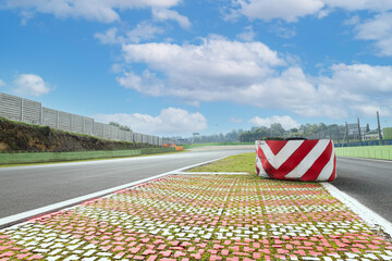 Wall Mural - Separation obstacle warning on asphalt track motor sport circuit pit lane entry