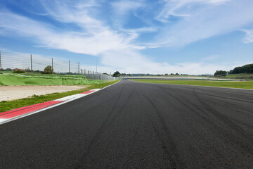 Motor sport circuit asphalt track background curb close up on straight and green field