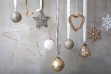 Christmas Decorations, Close Up Of Silver, White And Golden Christmas Baubles On Ribbons