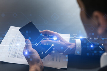 Businessman in office working with Smartphone, new technologies hologram to optimize the process, typing phone. Double exposure.