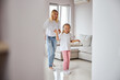 © Svitlana - Young blonde Caucasian woman in casual clothes having fun with small female child in home at the weekend