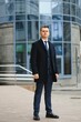 © Serhii - High fashion look.Young stylish confident handsome businessman model in suit clothes walking in the street.