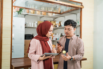 portrait young man and muslim woman talking about product sales