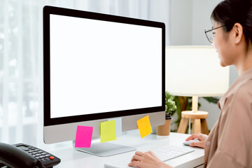 young asian woman sitting on chair and working at the computer with blank screen in home on the day 