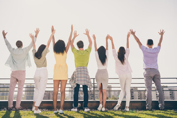 Wall Mural - Photo of funny pretty girls handsome guys standing hands up have fun party on roof terrace outside