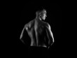 © Anetta - Muscular male torso of fit bodybuilder on black background in black and white