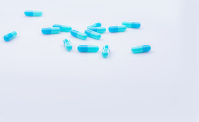 Canvas Print - Selective focus on blue capsule pill on white background. Pharmaceutical industry. Pharmacy products. Healthcare and medicine. Blue capsule pills with beautiful patterns. Pharmaceutical manufacturing.