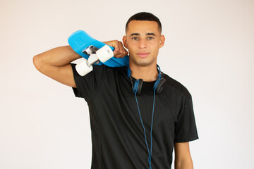 Young man in black t-shirt with a blue skateboard isolated on white background