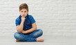 © yana_novak22 - boy 9-10 years old in a blue shirt on a light background, the emotion of resentment