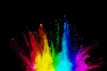 Wall Mural - explosion of colored powder on black background.