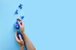 © Анастасия Бурлакова - Top view of female hands with hydrangea flowers on blue background. Fashion art and beauty flatlay, colored shadows. Concept hand care