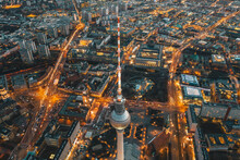 Wide View Of Beautiful Berlin, Germany Cityscape After Sunset With Lit Up Streets And Alexanderplatz TV Tower, Aerial Drone View