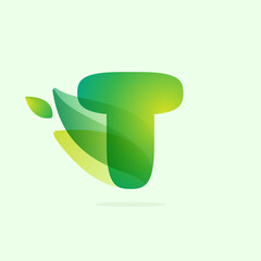 Ecology T letter logo with green leaves.