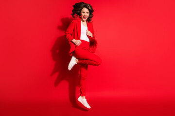 Wall Mural - Full length photo of stunning young lady jump open mouth wear blazer pants footwear isolated red color background