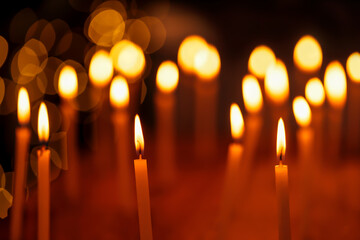 Candles Illuminated On Christmas. Beautiful group of candles lit during Diwali Festival night with light bokeh background. Concept for holiday, festive celebration, hanukkah, christmas, church, temple