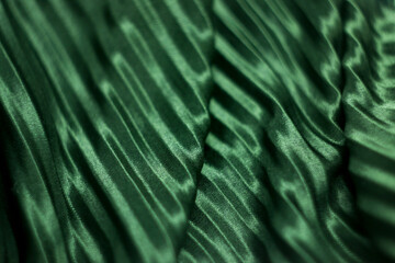 texture, background, pattern, silk fabric of green color. green silk. pleated fabric.