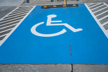 Blue Handicap At Parking Car Sign Outdoors For Disabled, Wheelchair Or Elder Old Or Cannot Self Help People