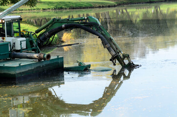 Floating dredge deepens the bottom of the water-management environment.