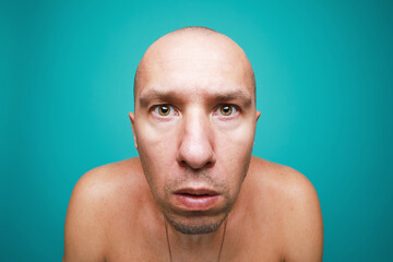 Portrait of funny naked bald man isolated on green background 