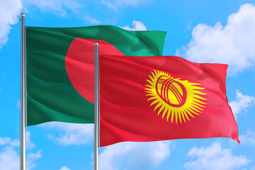 Kyrgyzstan and Bangladesh national flag waving in the windy deep blue sky. Diplomacy and international relations concept.