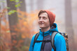 © ArtmannWitte - Young man hiking with backpack in a forest in fall