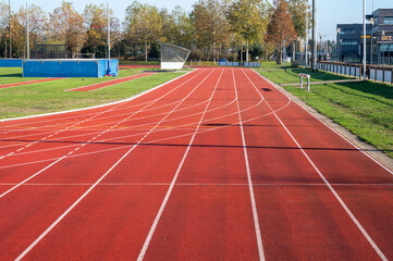 Red running lane on outdoor school stadium